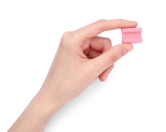 Photo of Woman holding tasty pink chewing gum on white background, top view