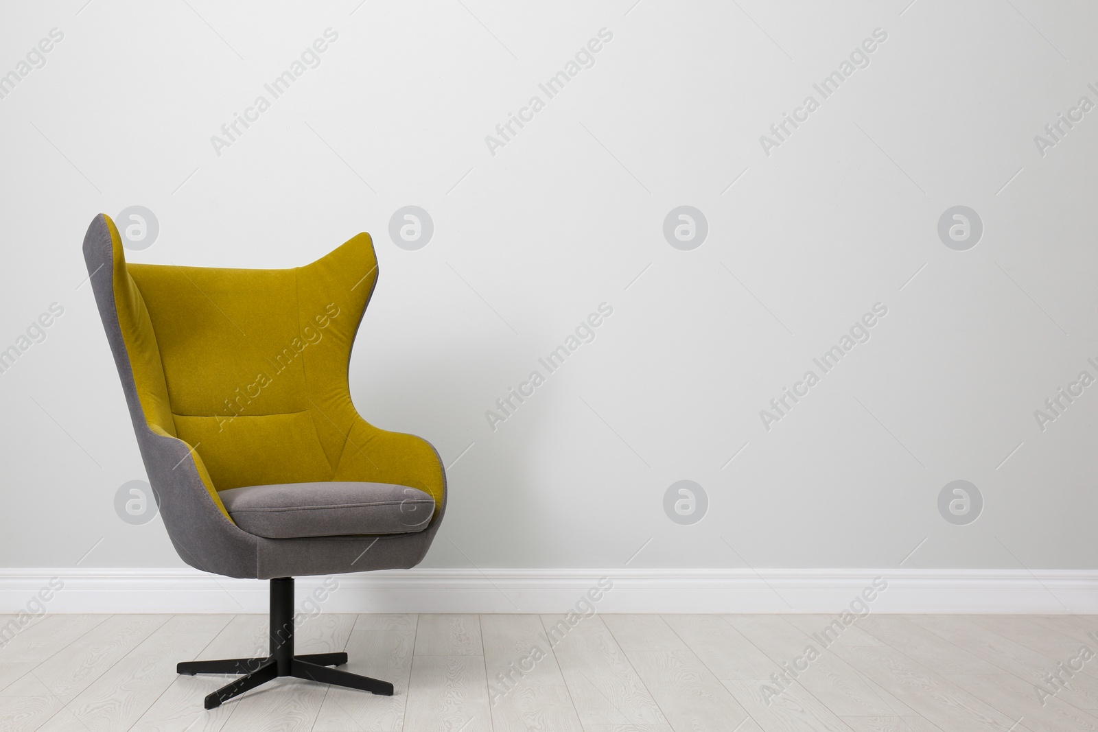 Photo of Comfortable office chair near light wall indoors. Space for text