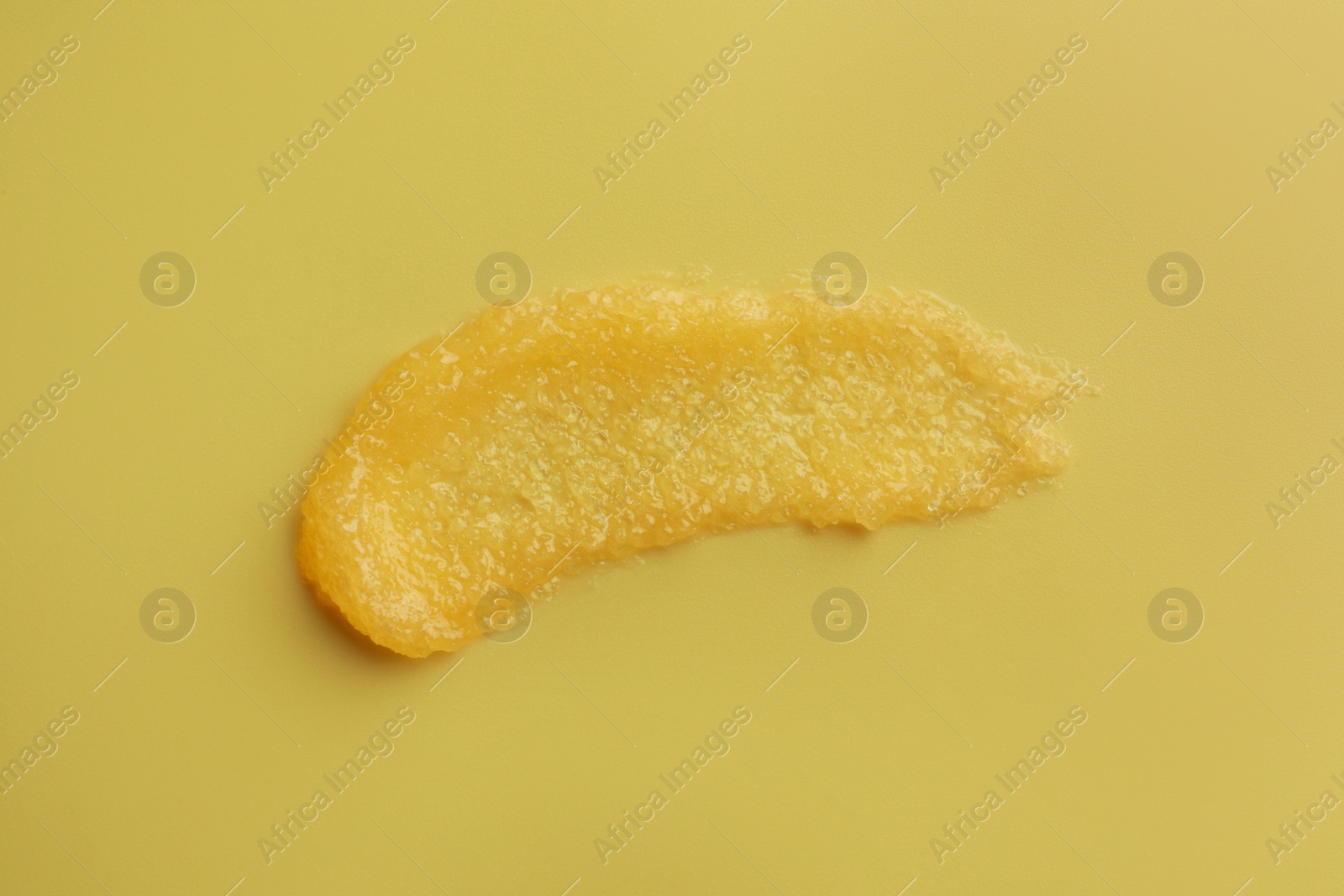 Photo of Sample of face mask on yellow background, top view