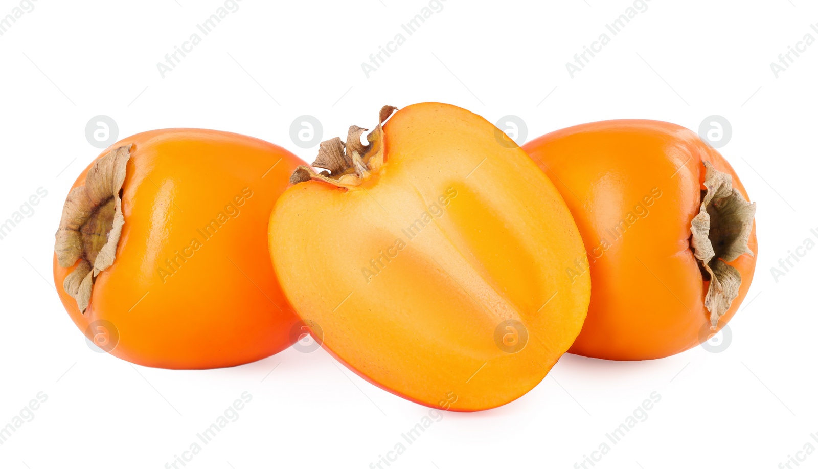 Photo of Whole and cut persimmon fruits isolated on white