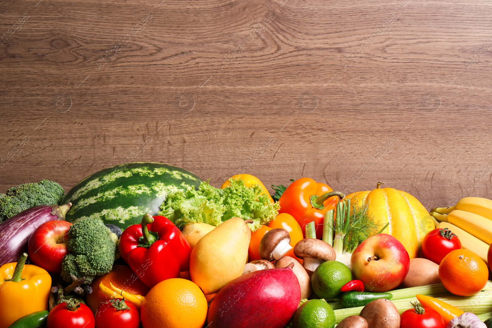 Photo of Assortment of fresh organic fruits and vegetables on wooden background, closeup. Space for text