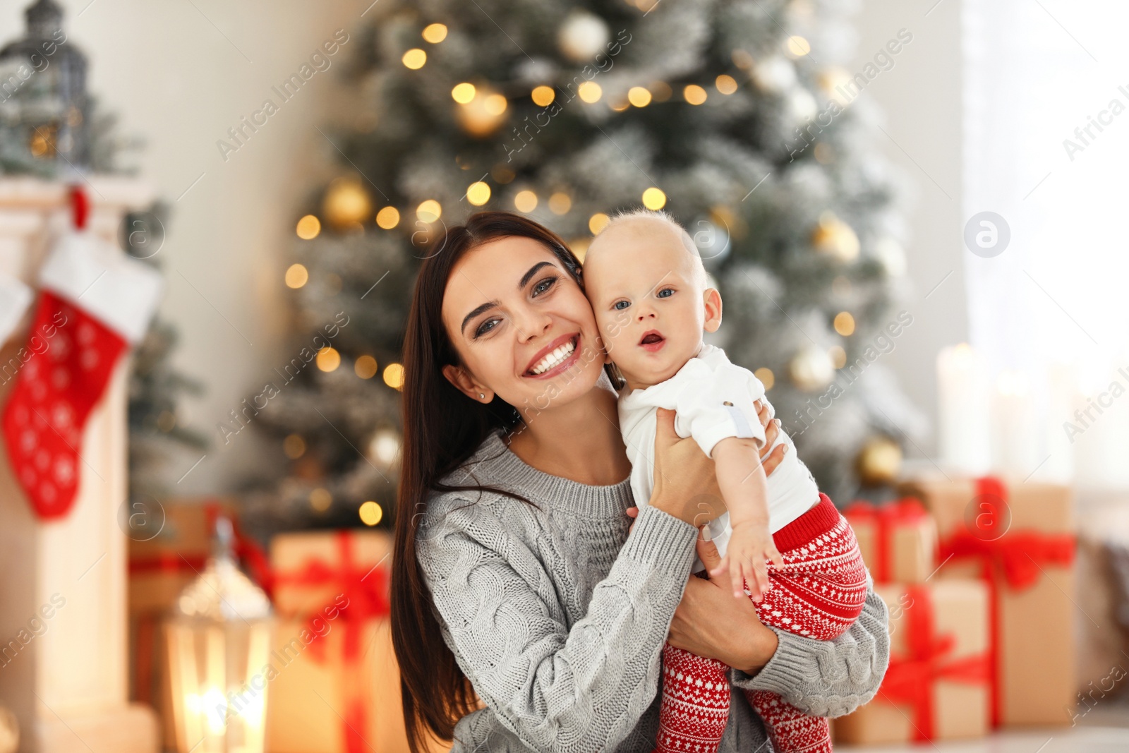 Photo of Mother with her cute baby at home. Christmas celebration