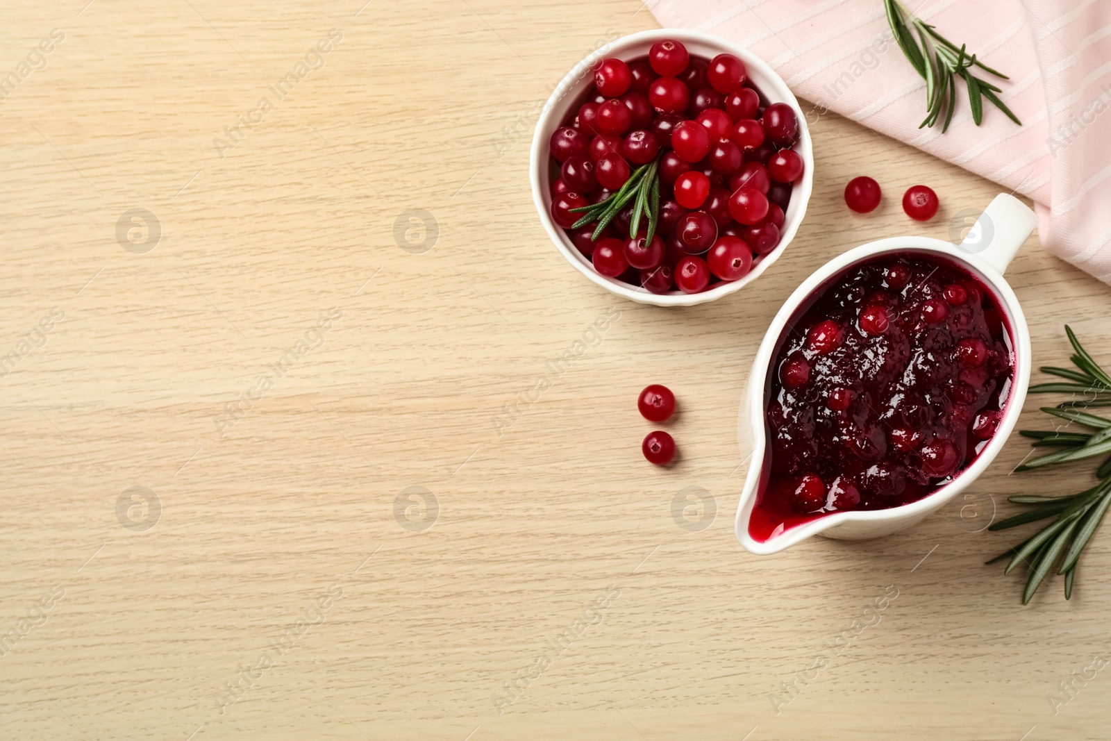 Photo of Flat lay composition with cranberry sauce on wooden table, space for text