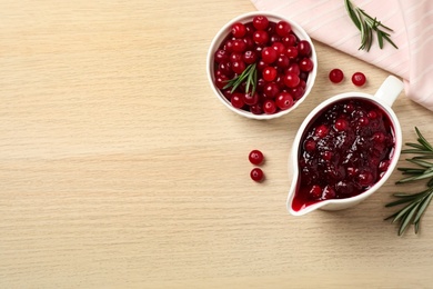 Photo of Flat lay composition with cranberry sauce on wooden table, space for text