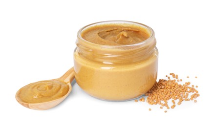 Photo of Fresh tasty mustard sauce in jar, spoon and dry seeds isolated on white