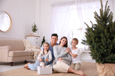 Happy family with cute children near Christmas tree together at home