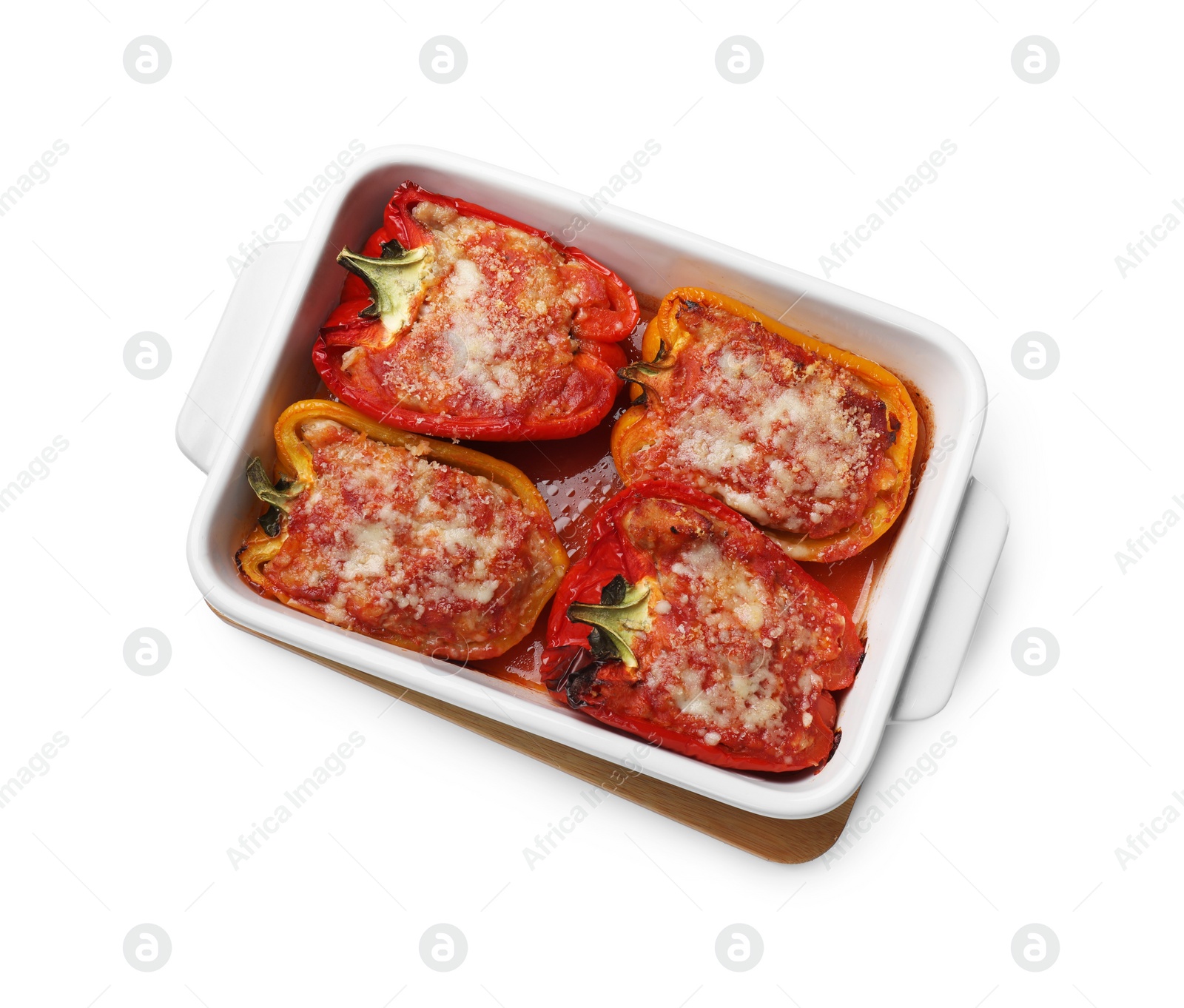 Photo of Tasty stuffed peppers in dish isolated on white, top view