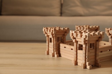 Photo of Wooden fortress on table indoors, space for text. Children's toy