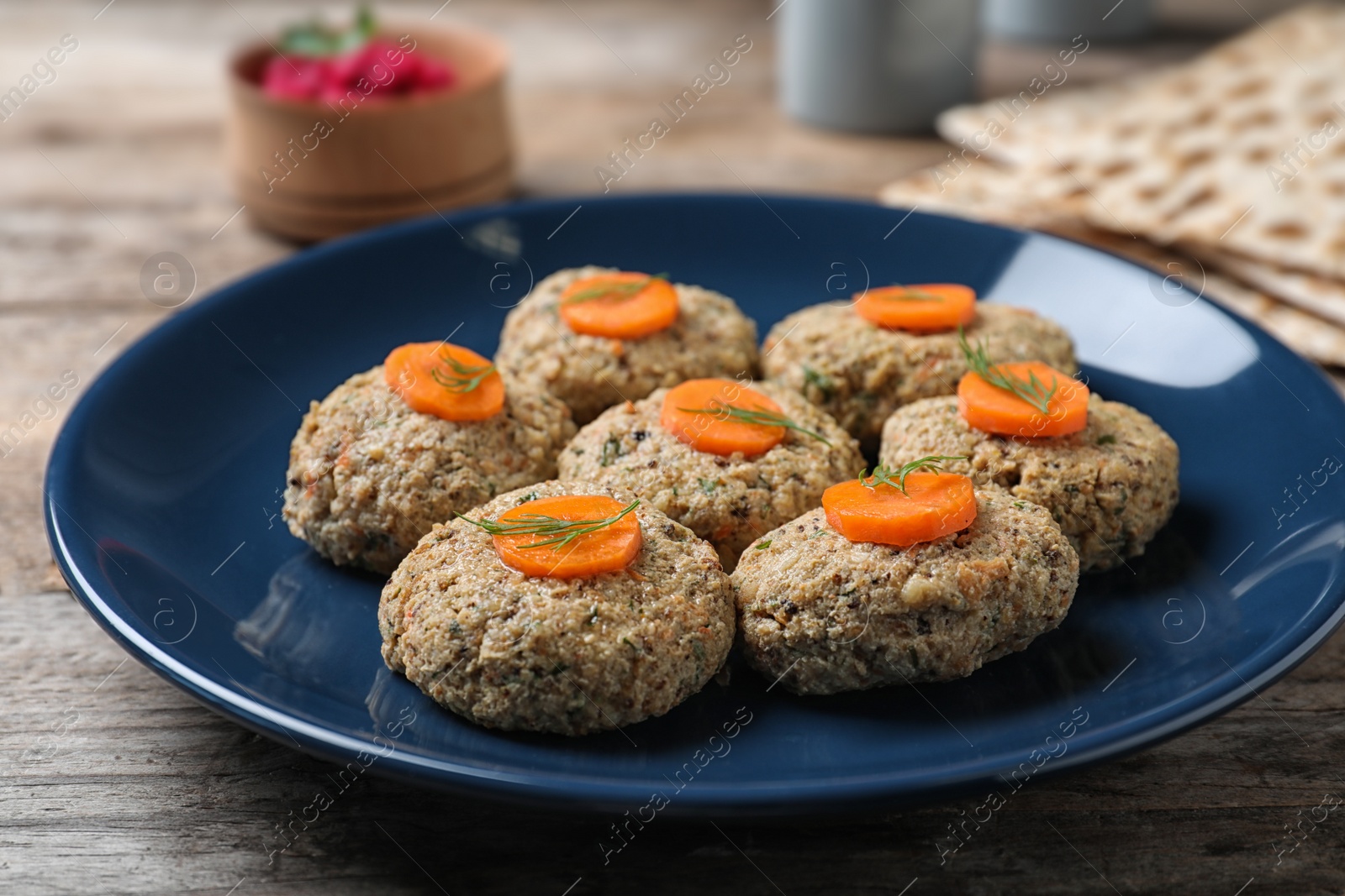 Photo of Plate of traditional Passover (Pesach) gefilte fish on wooden table, closeup