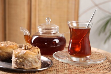 Traditional Turkish tea and fresh baklava on wicker table