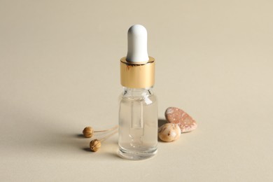 Photo of Composition with bottle of cosmetic serum on beige background