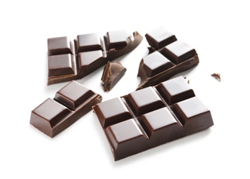 Photo of Pieces of tasty dark chocolate on white background