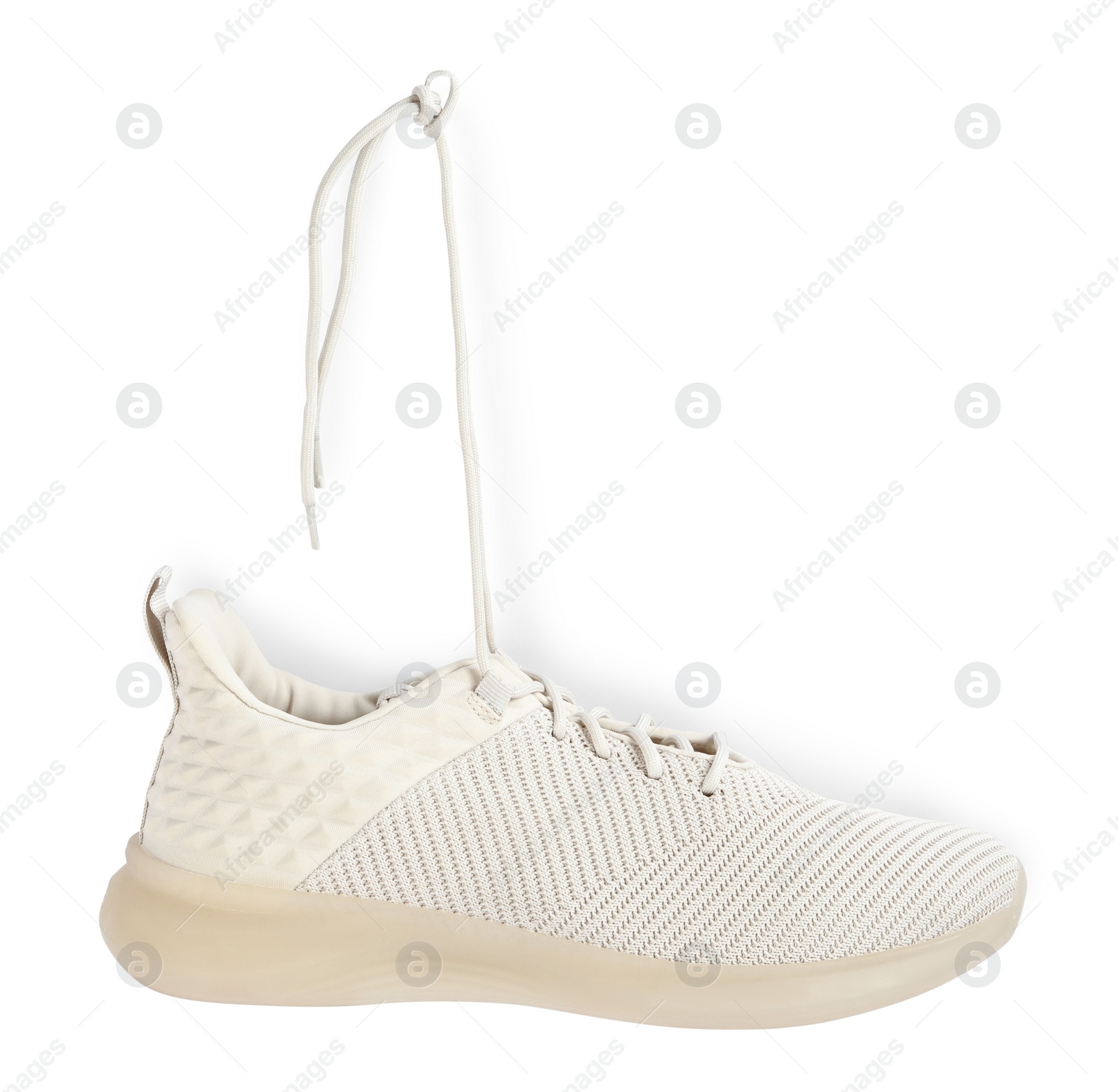 Photo of Stylish shoe with laces hanging on white background