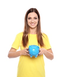 Young woman with piggy bank on white background