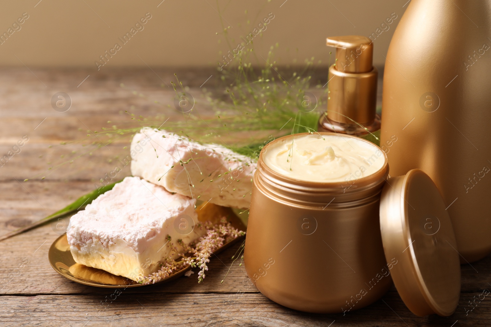 Photo of Hair cosmetic products on wooden table, closeup