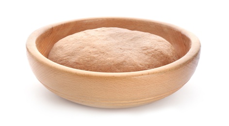 Bowl with raw rye dough on white background