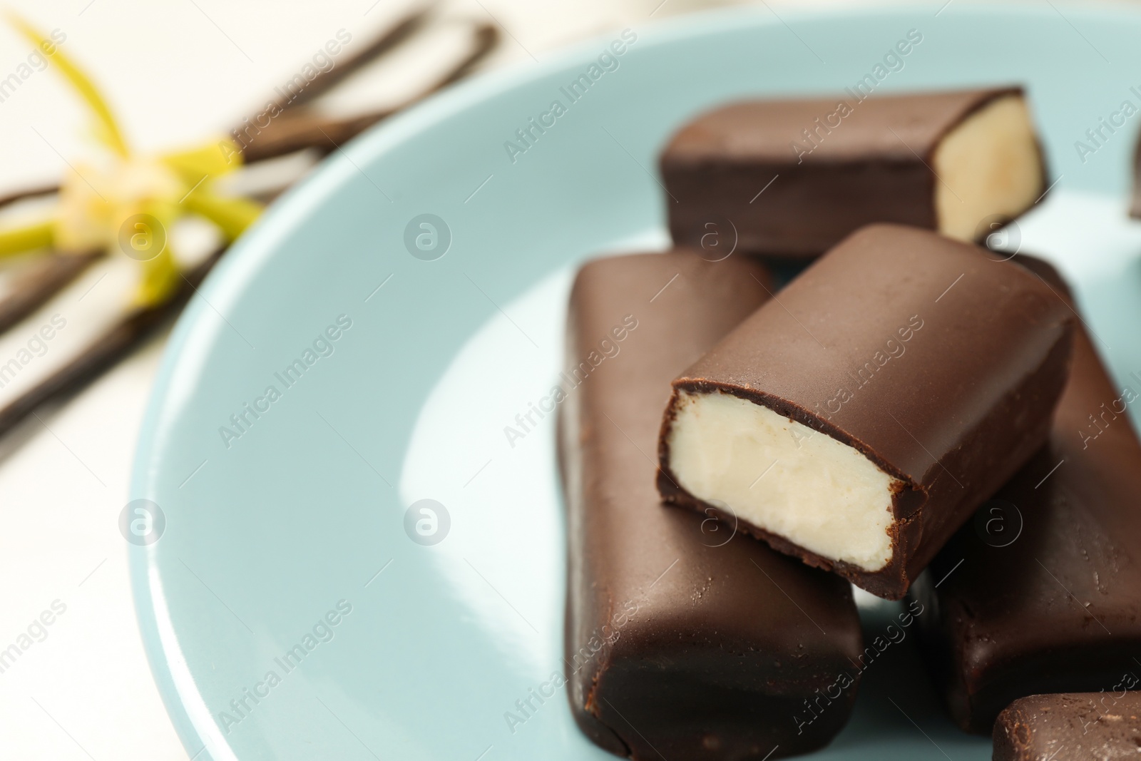 Photo of Glazed curd cheese bars on white table, closeup