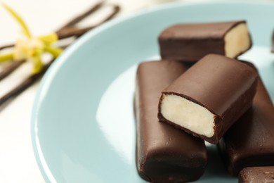 Photo of Glazed curd cheese bars on white table, closeup