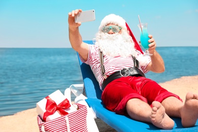 Photo of Authentic Santa Claus taking selfie at resort