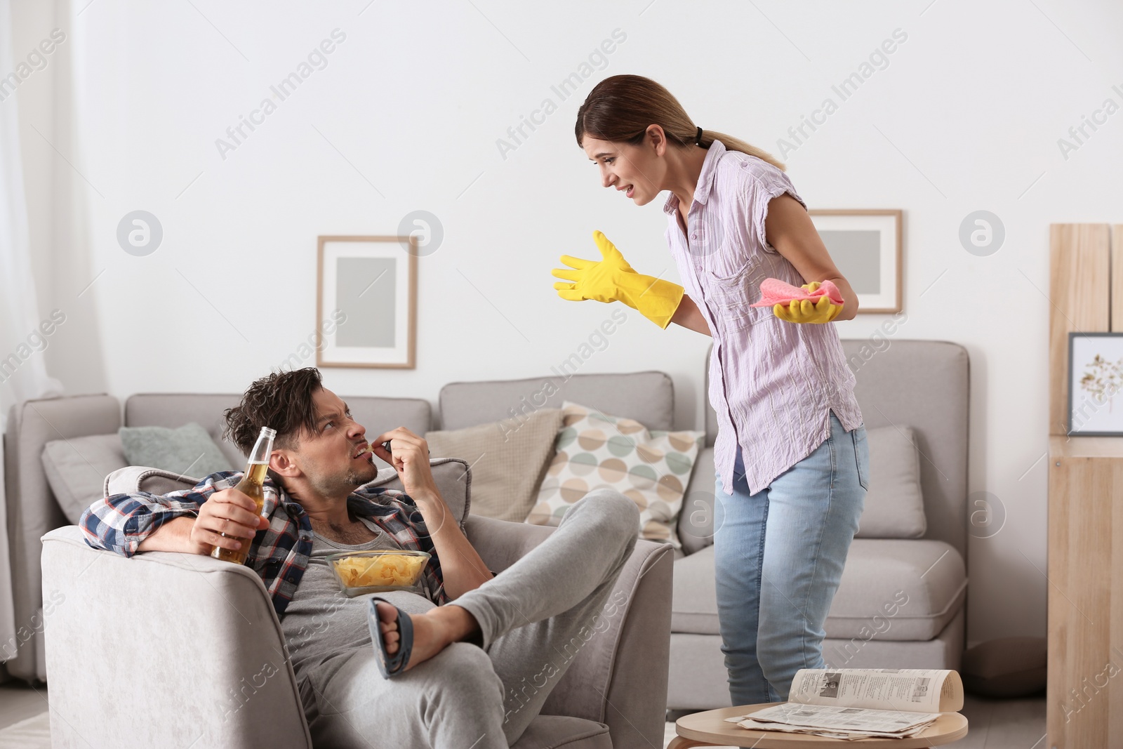 Photo of Lazy husband quarrelling with hardworking wife at home