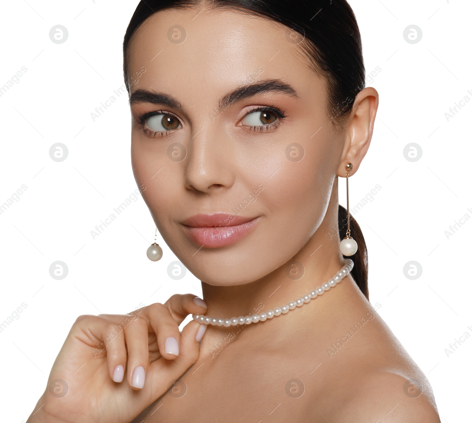 Photo of Young woman wearing elegant pearl jewelry on white background