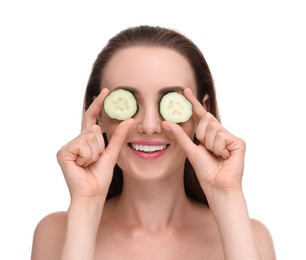 Beautiful woman covering eyes with pieces of cucumber on white background