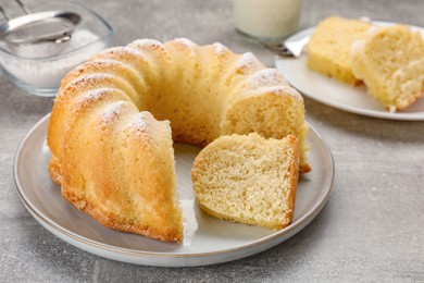 Photo of Delicious freshly baked sponge cake on gray table, closeup