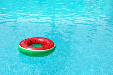 Photo of Inflatable ring floating in pool on sunny day