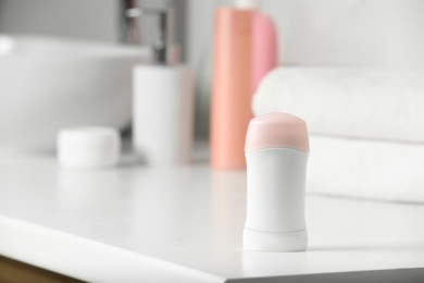 Stick deodorant with toiletry on countertop in bathroom, space for text