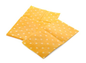 Photo of Yellow reusable beeswax food wraps on white background