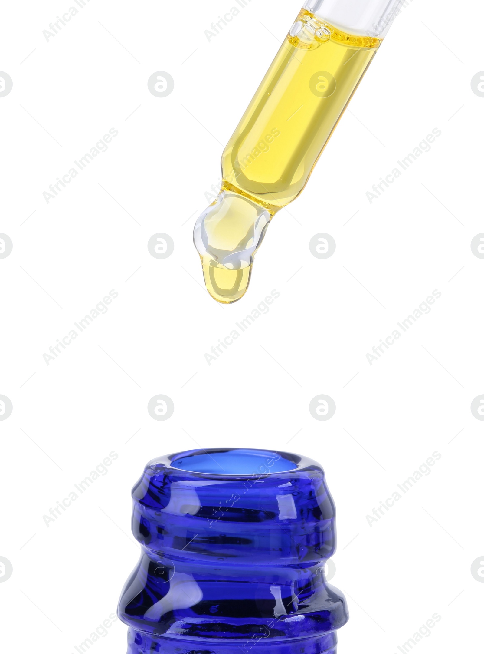 Photo of Dripping tincture from pipette into bottle isolated on white