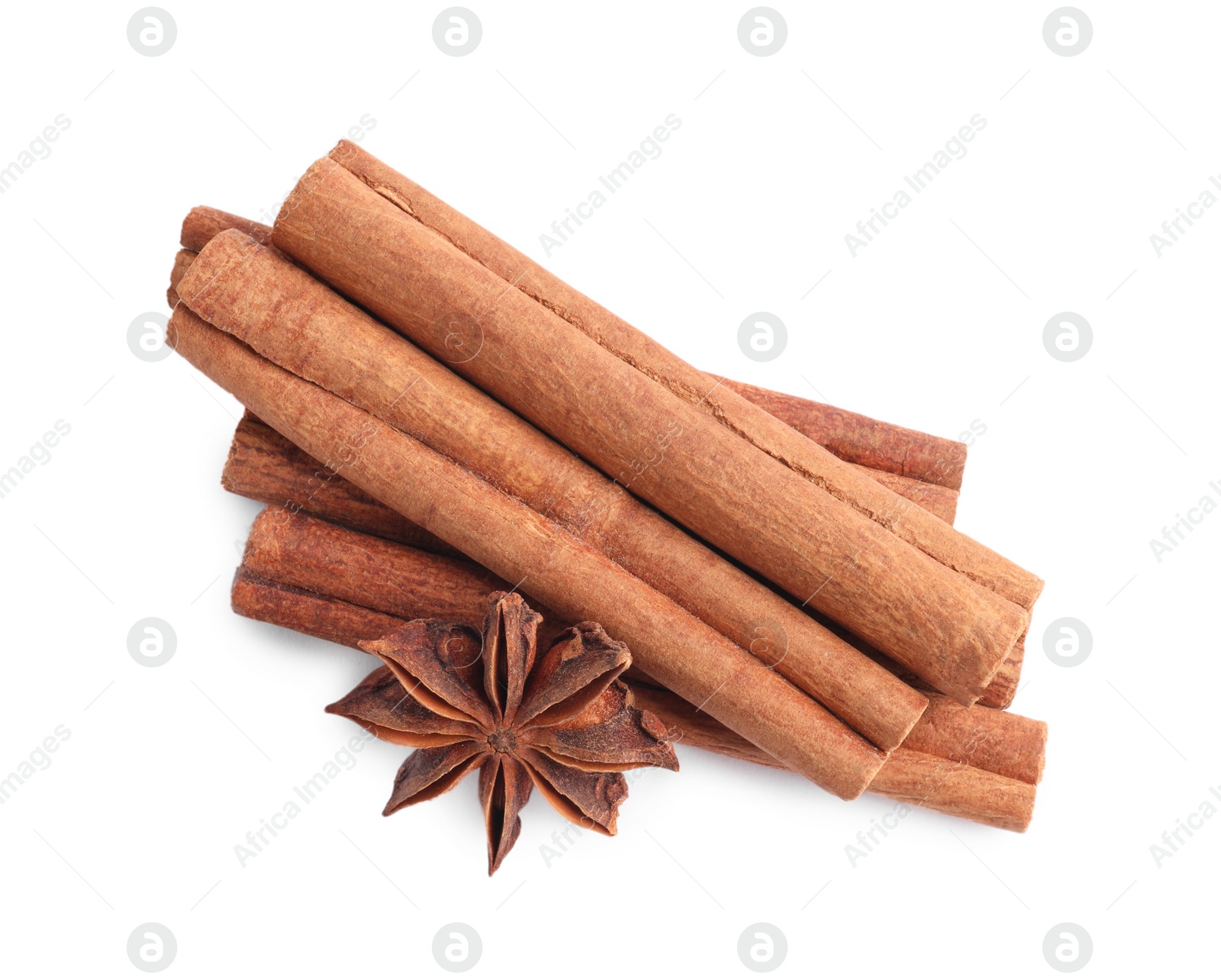 Photo of Aromatic cinnamon sticks and anise stars isolated on white, top view