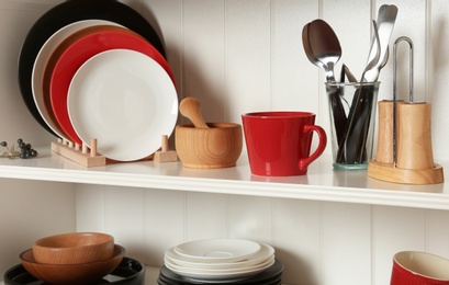 White shelving unit with set of dishware