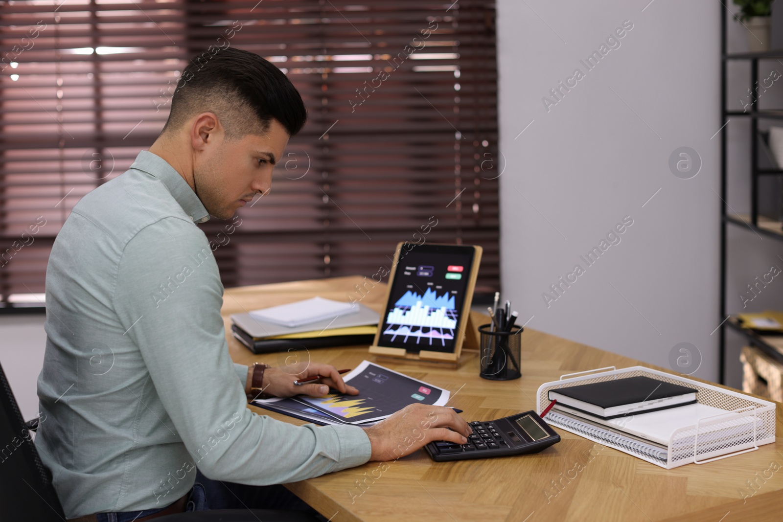 Photo of Businessman working with graph in office, space for text. Forex trading