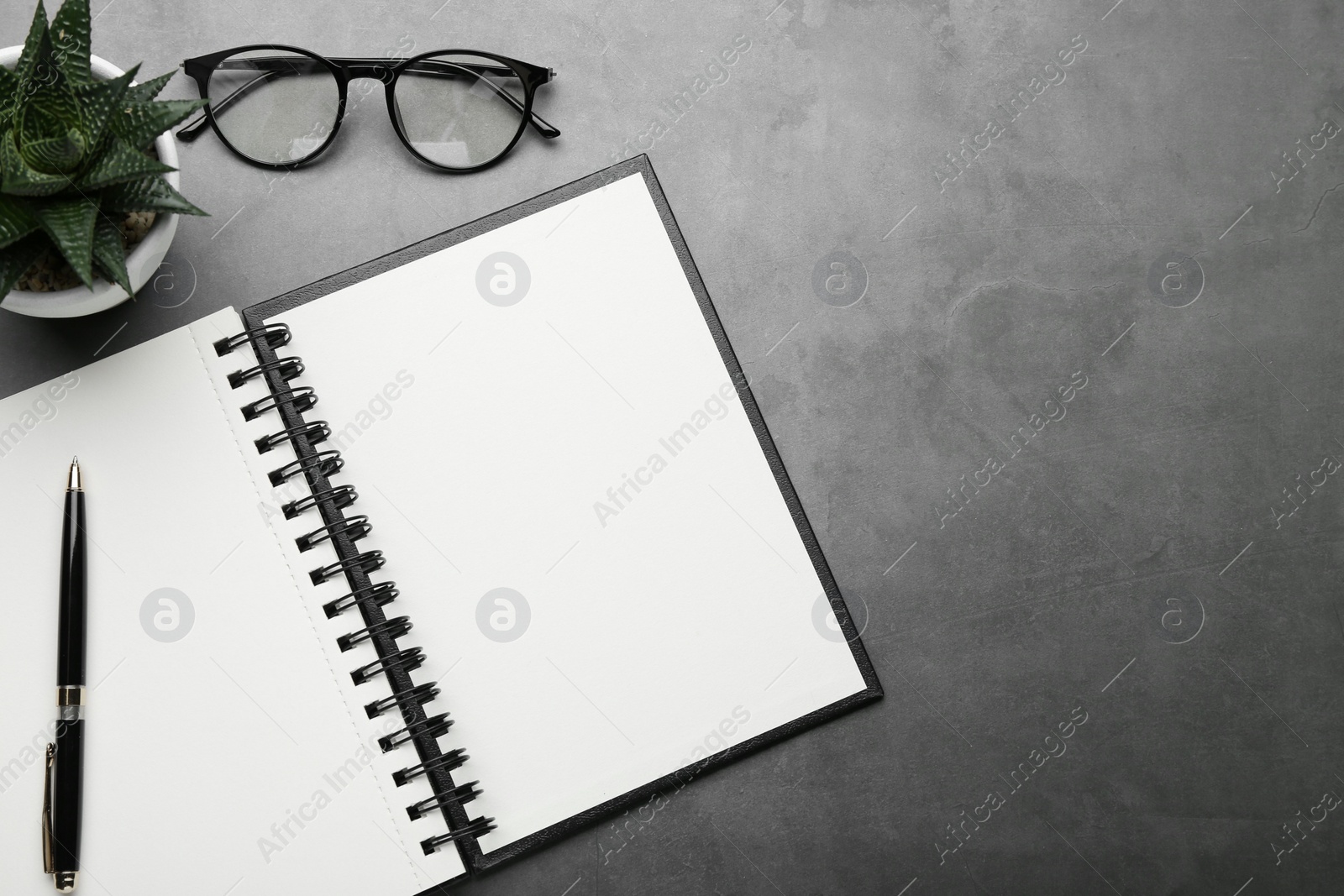 Photo of Flat lay composition with notebook on grey table