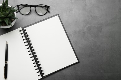 Photo of Flat lay composition with notebook on grey table