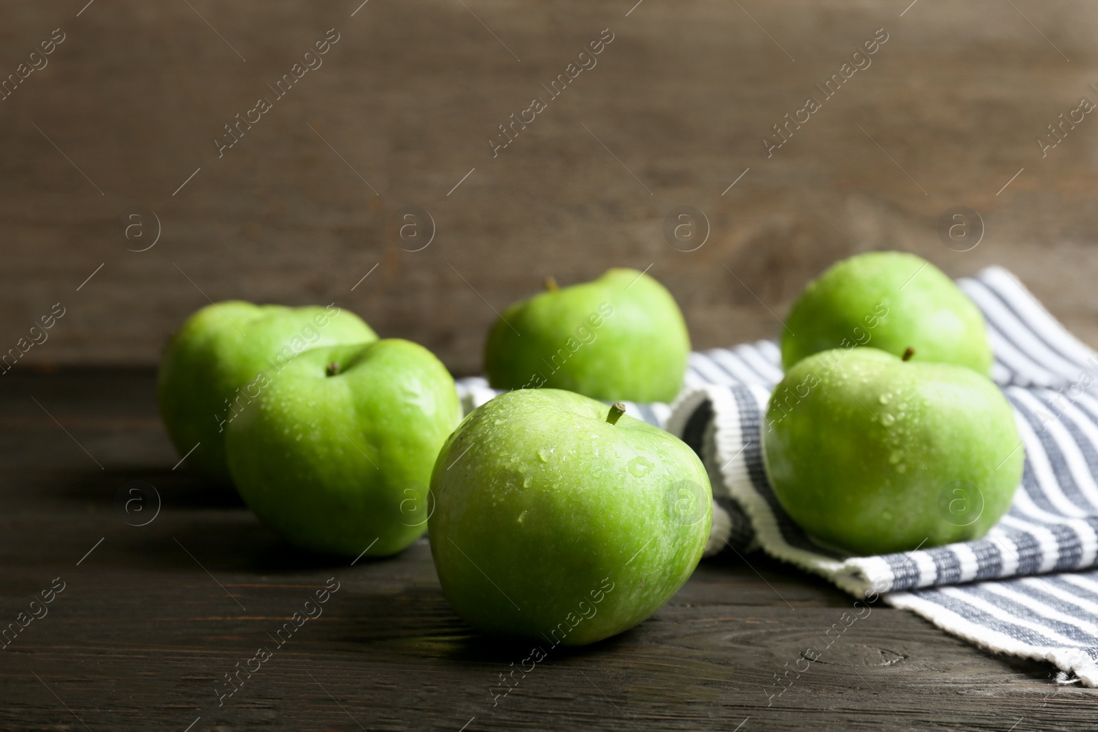 Photo of Fresh green apples on wooden table