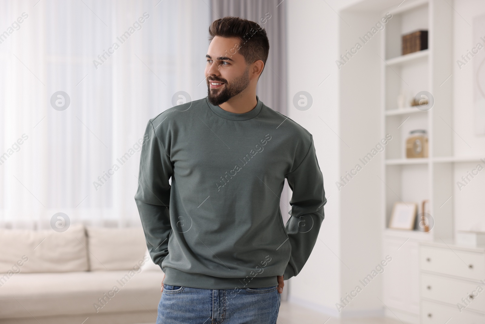 Photo of Happy man in stylish sweater at home