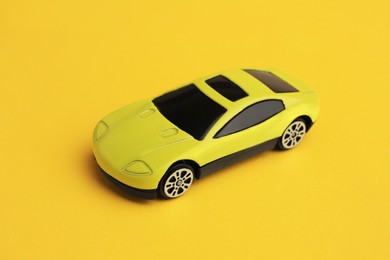 One bright car on yellow background. Children`s toy