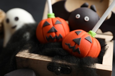 Photo of Different delicious Halloween themed cake pops, closeup