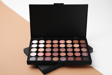 Eye shadow palette on colorful background. Product for makeup