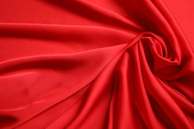 Photo of Texture of delicate red silk as background, top view