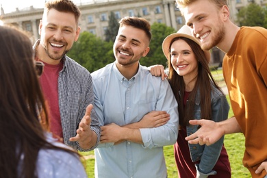 Happy people spending time together outdoors on sunny day