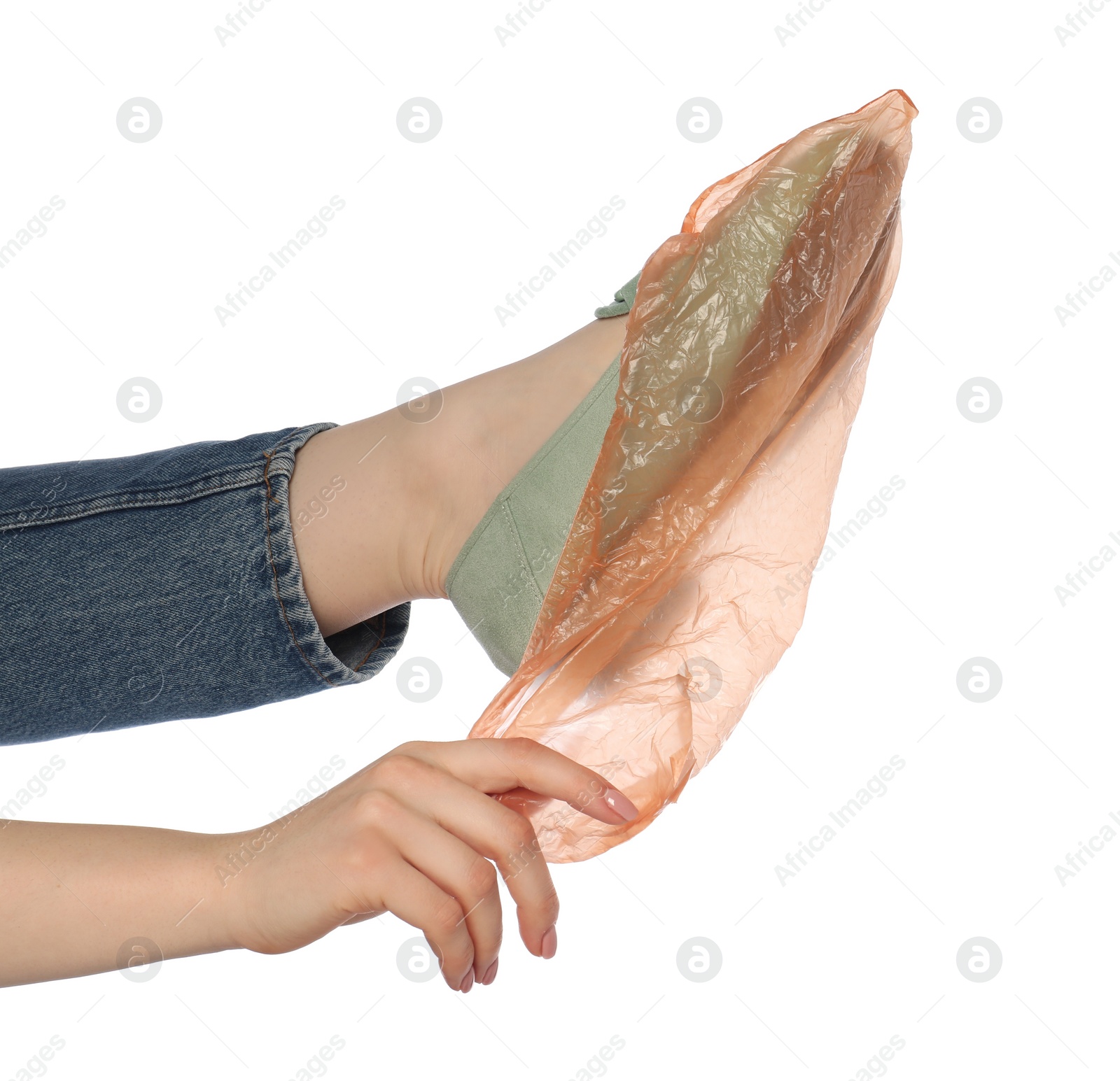 Photo of Woman wearing shoe cover onto her footwear against white background, closeup