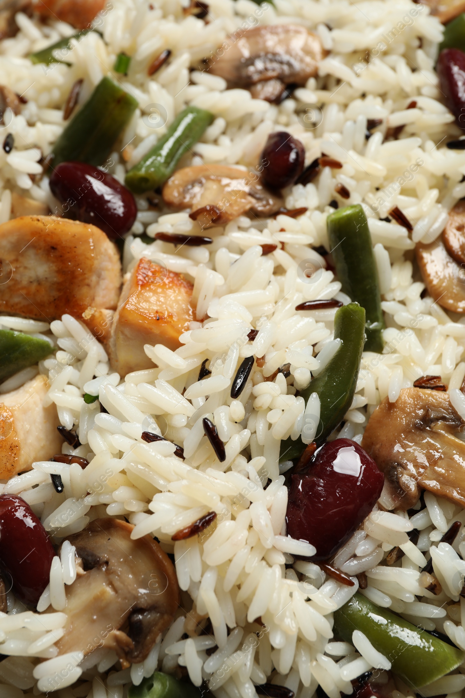 Photo of Delicious rice pilaf with chicken and vegetables as background, closeup