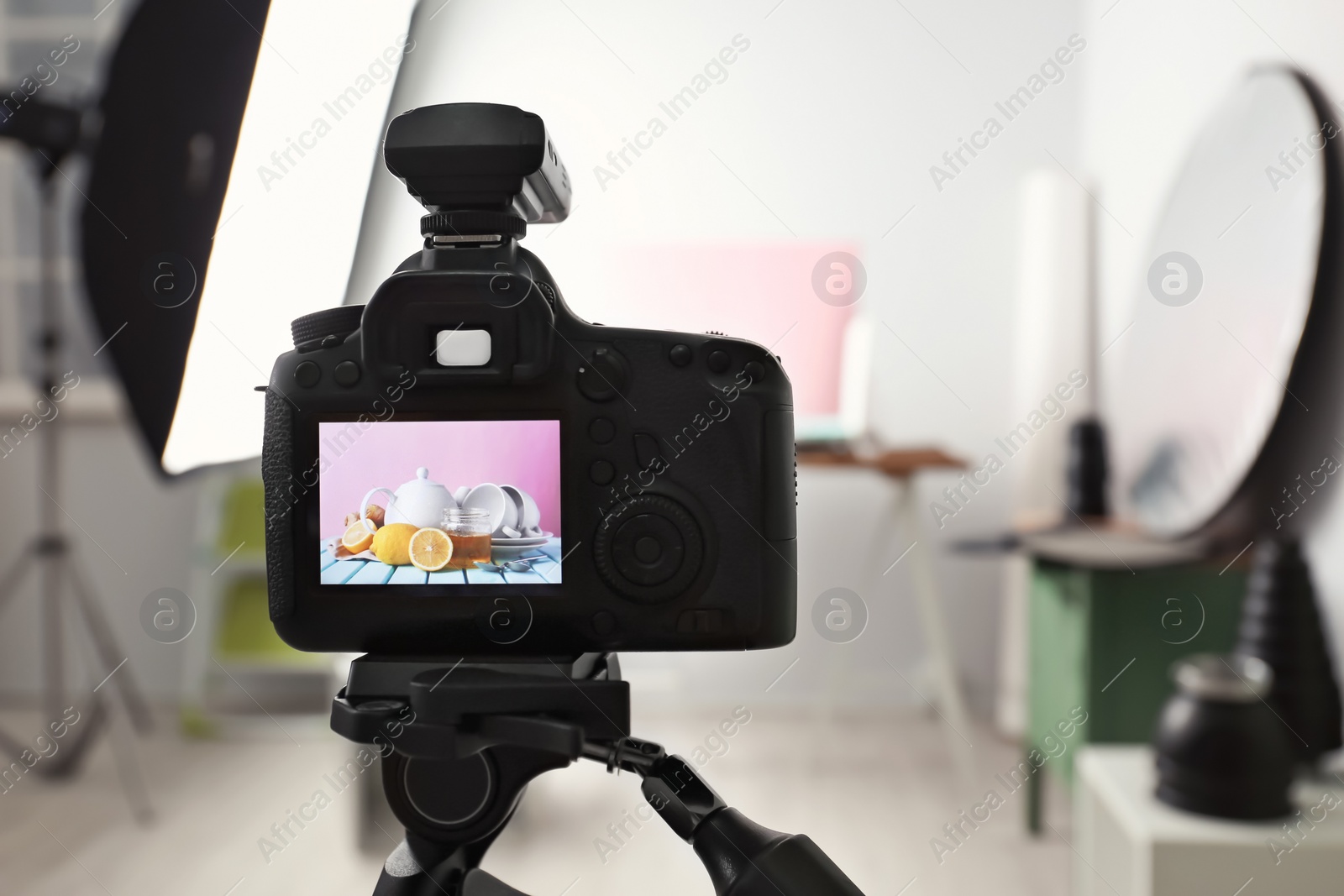 Photo of Professional camera on tripod in studio, closeup. Food photography