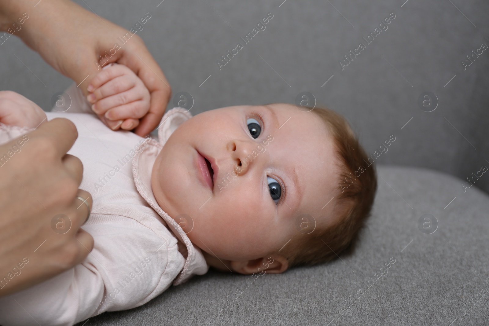 Photo of Young woman with her little baby resting after breast feeding at home, closeup