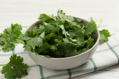 Photo of Fresh aromatic cilantro on white wooden table, closeup