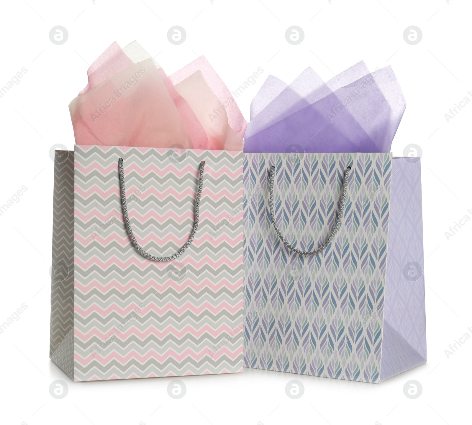 Photo of Gift bags with paper on white background