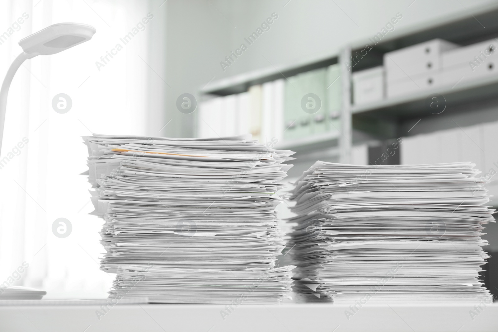 Photo of Stacks of documents on table in office